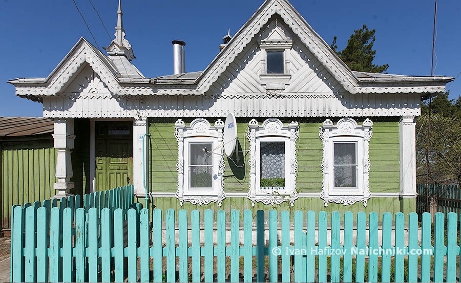 A fine wooden house with nalichniki (old wooden Russian window frames) and satellite dish