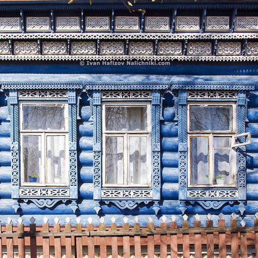 Front part of wooden house and nalichniki with fretwork